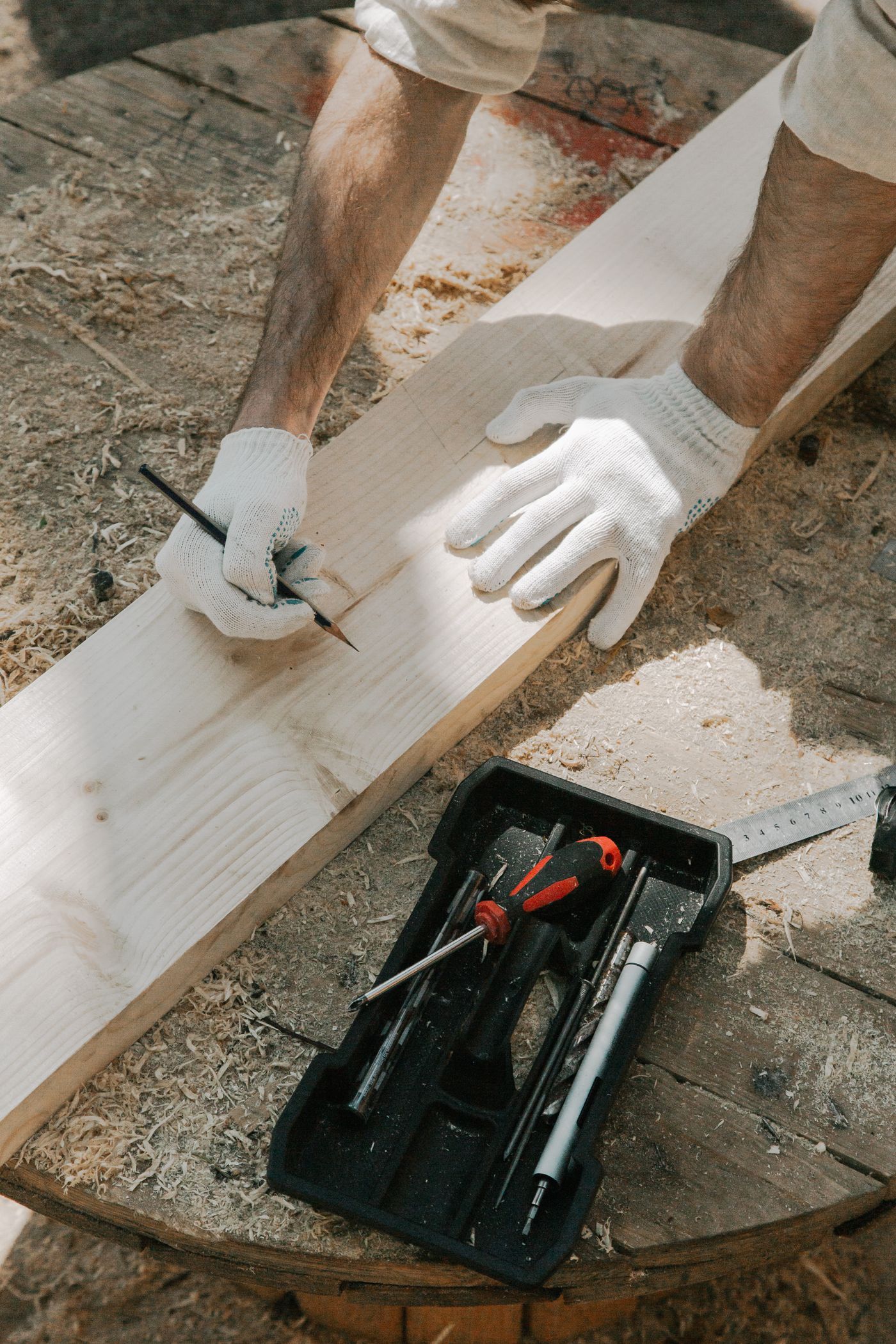An MNM carpenter marking out timber on site